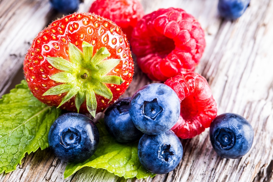 mixed wildberries on wooden background