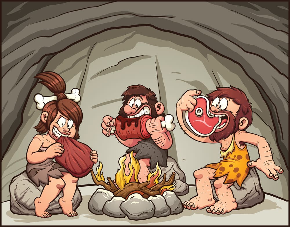 Cartoon cavemen eating around the fire