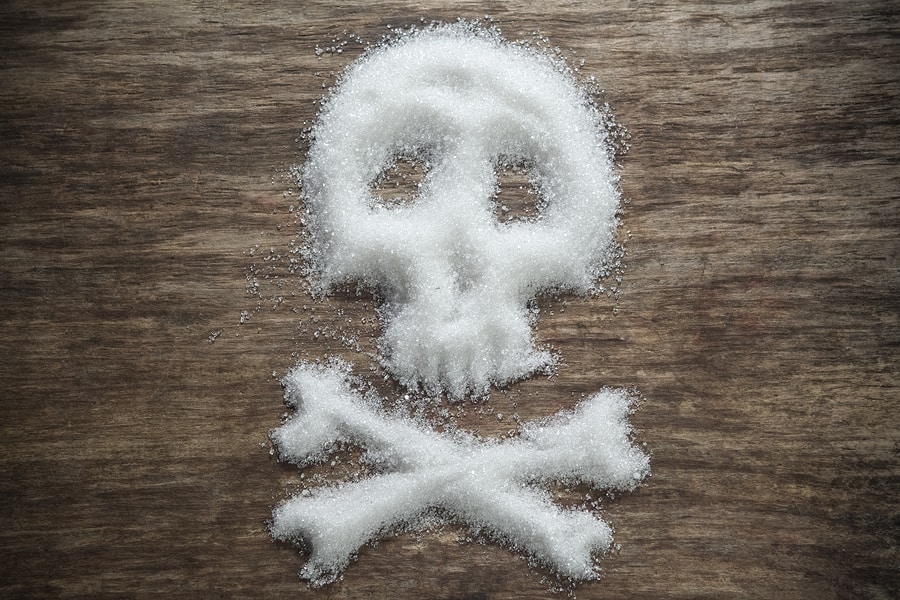 skull-shaped refined sugar powder on wooden background