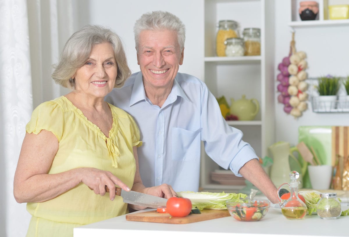 Happy senior man and woman in the kitchen