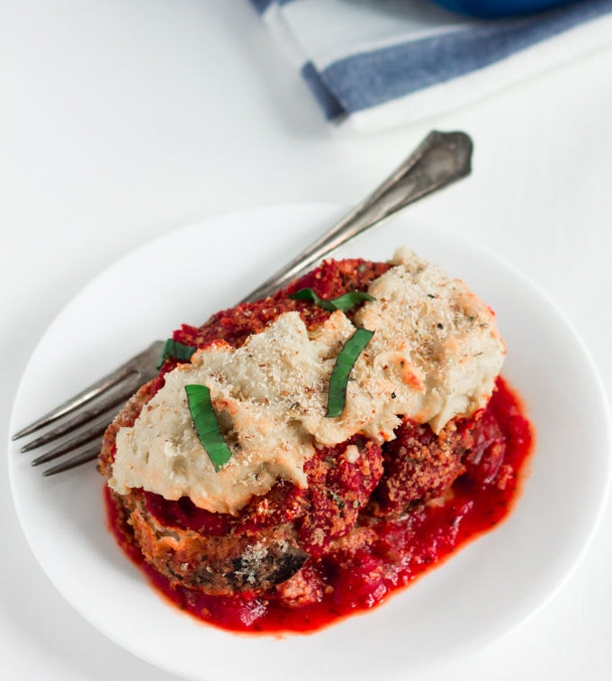 Seriously, where's the egg? This Vegan Fried Eggplant Casserole (AKA eggplant parmesan) is nothing like you've seen before. Making this dish Gluten-free, Egg-Free, Dairy-Free, Vegan, Flourless and Paleo was truly a feat... But I made it! In the traditional recipe, the eggplant is usually coated with egg then panko or Italian breadcrumbs. Not here. This recipe is 100% healthy, made with real unprocessed food and so, so good...! | www.onecleverchef.com