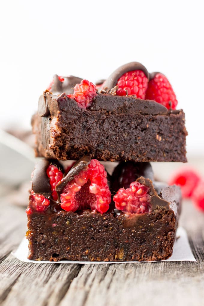 These healthy Raspberry and Chocolate Protein Brownies are deliciously moist and extra rich. Naturally sweetened, this melt in your mouth protein snack is the perfect post-workout treat. Made with dates and almond flour, this guilt-free, decadent dessert is also paleo, vegan, gluten-free, dairy-free, egg-free and flourless. | www.onecleverchef.com