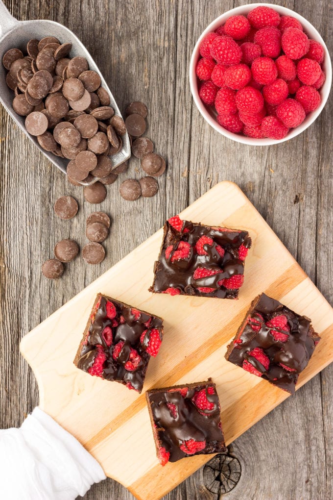 These healthy Raspberry and Chocolate Protein Brownies are deliciously moist and extra rich. Naturally sweetened, this melt in your mouth protein snack is the perfect post-workout treat. Made with dates and almond flour, this guilt-free, decadent dessert is also paleo, vegan, gluten-free, dairy-free, egg-free and flourless. | www.onecleverchef.com