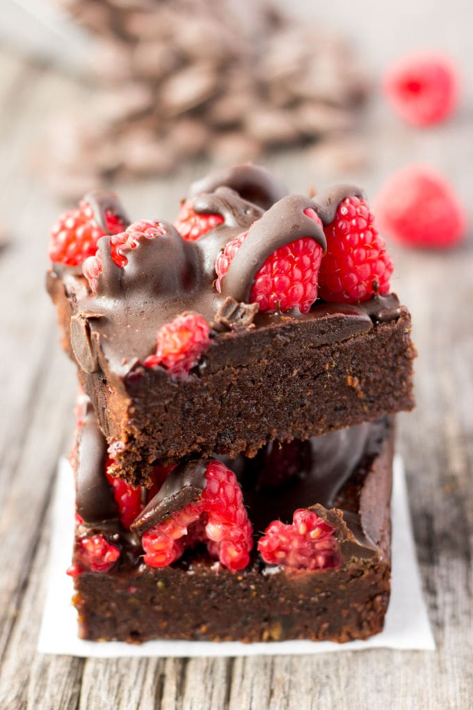 These healthy Raspberry and Chocolate Protein Brownies are deliciously moist and extra rich. Naturally sweetened, this melt in your mouth protein snack is the perfect post-workout treat. Made with dates and almond flour, this guilt-free, decadent dessert is also paleo, vegan, gluten-free, dairy-free, egg-free and flourless. | www.onecleverchef.com