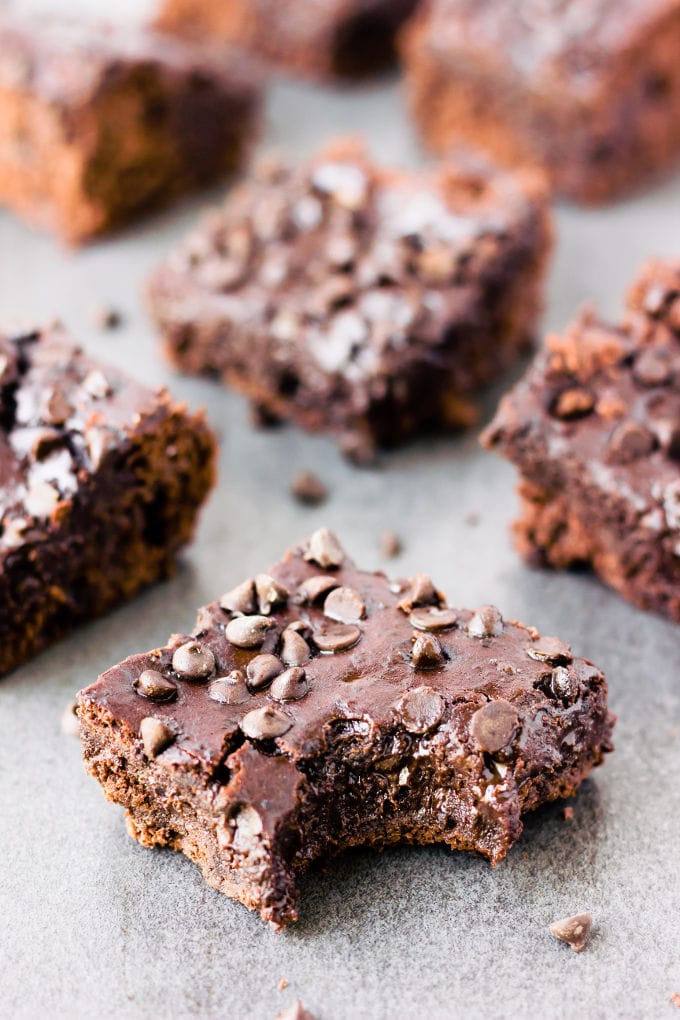 These rich and fudgy black bean protein brownies are the perfect post-workout treat! This super healthy snack is entirely flourless, gluten-free, vegan, dairy-free, egg-free, refined sugar-free and nut-free. Naturally sweetened with maple syrup and filled with antioxidants, these delicious brownie protein bars only require a few minutes of your time and a good food processor. | www.onecleverchef.com