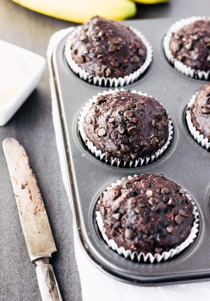 These delicious chocolate protein muffins are the perfect way to reward yourself after a hard workout. Super moist and cakey, these healthy chocolate protein snacks are naturally sweetened with banana and maple syrup. Gluten-free, vegan, dairy-free, egg-free, flourless, kid-friendly and refined sugar-free. | www.onecleverchef.com