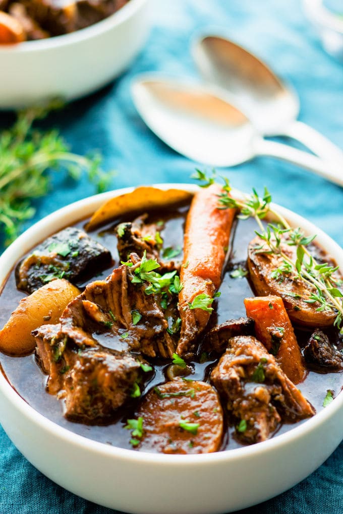 This slow cooker gluten-free beef bourguignon (or Beef Burgundy) recipe is the best I have ever tried. Cooking it in a slow cooker makes it super easy to prepare and extra tasty! My very simple version of this classic French stew is entirely gluten-free and can be made paleo by picking the right red wine for this particular diet. | www.onecleverchef.com #paleo #gluten-free #comfortfood #stew #beefbourguignon #slowcooker #healthy #weeknight #crockpot