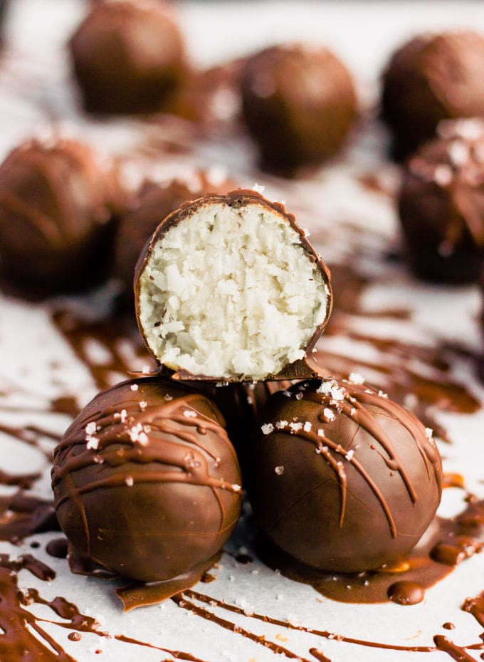 These chocolate covered protein bounty balls are a healthy, homemade version of the classic candy bar. Made of only 6 simple ingredients, these easy to make protein balls are the perfect post-workout treat. This no-bake recipe is also paleo, vegan, gluten-free, flourless, dairy-free and… guilt-free! | www.onecleverchef.com #paleo #vegan #glutenfree #postworkout #protein #healthy #treat #cleaneating