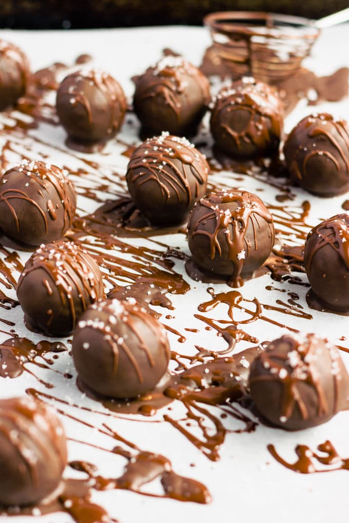 These chocolate covered protein bounty balls are a healthy, homemade version of the classic candy bar. Made of only 6 simple ingredients, these easy to make protein balls are the perfect post-workout treat. This no-bake recipe is also paleo, vegan, gluten-free, flourless, dairy-free and… guilt-free! | www.onecleverchef.com #paleo #vegan #glutenfree #postworkout #protein #healthy #treat #cleaneating