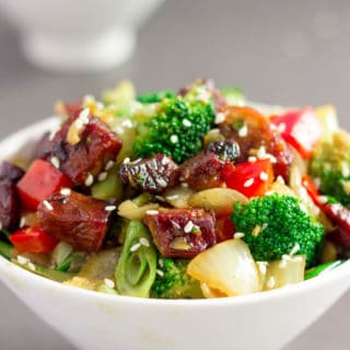 This Hoisin Pork Stir-Fry recipe is the perfect weeknight meal. Simple, no-fuss and quick, this delicious recipe is made with only 8 ingredients and one pan. This recipe was created with a roast pork tenderloin leftover, some green onions, and common vegetables. It is very adaptable as you can swap the meat or veggies with whatever is left in the fridge. Do you have leftover beef or chicken? This recipe has you covered. So don't stress, you probably won't have to hop to the grocery store to make this one! Paleo, Gluten-Free, and Dairy-Free. | Onecleverchef.com