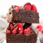 These healthy Raspberry and Chocolate Protein Brownies are deliciously moist and extra rich. Naturally sweetened, this melt in your mouth protein snack is the perfect post-workout treat. Made with dates and almond flour, this guilt-free, decadent dessert is also paleo, vegan, gluten-free, dairy-free, egg-free and flourless.