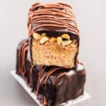 These healthy snickers proteins bars are a homemade copycat of the original bar which taste just like it. Made with 100% real food, guilt-free ingredients, this delicious protein snack is gluten-free, paleo, vegan, dairy-free, egg-free, flourless and kid-friendly! www.onecleverchef.com