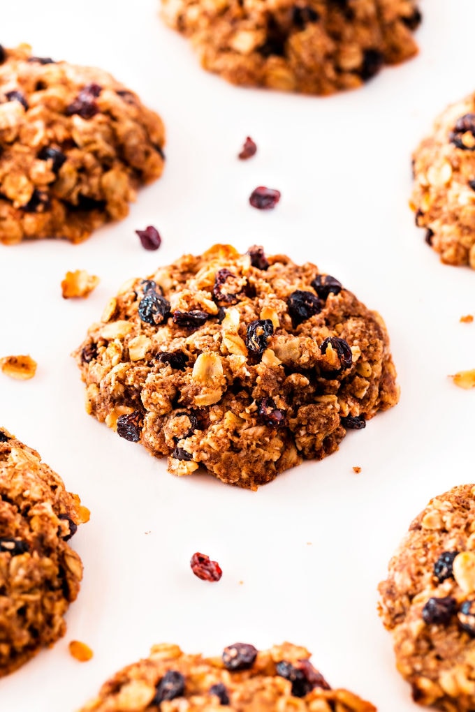 Several oatmeal raisin cookies placed on a white background.