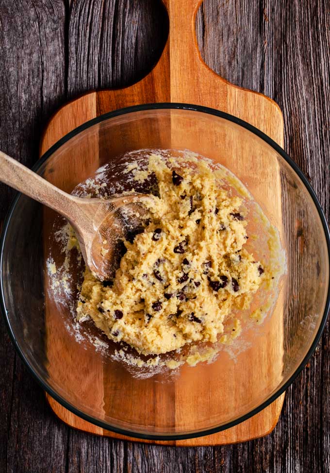 Freshly stirred cookie dough on a wooden board