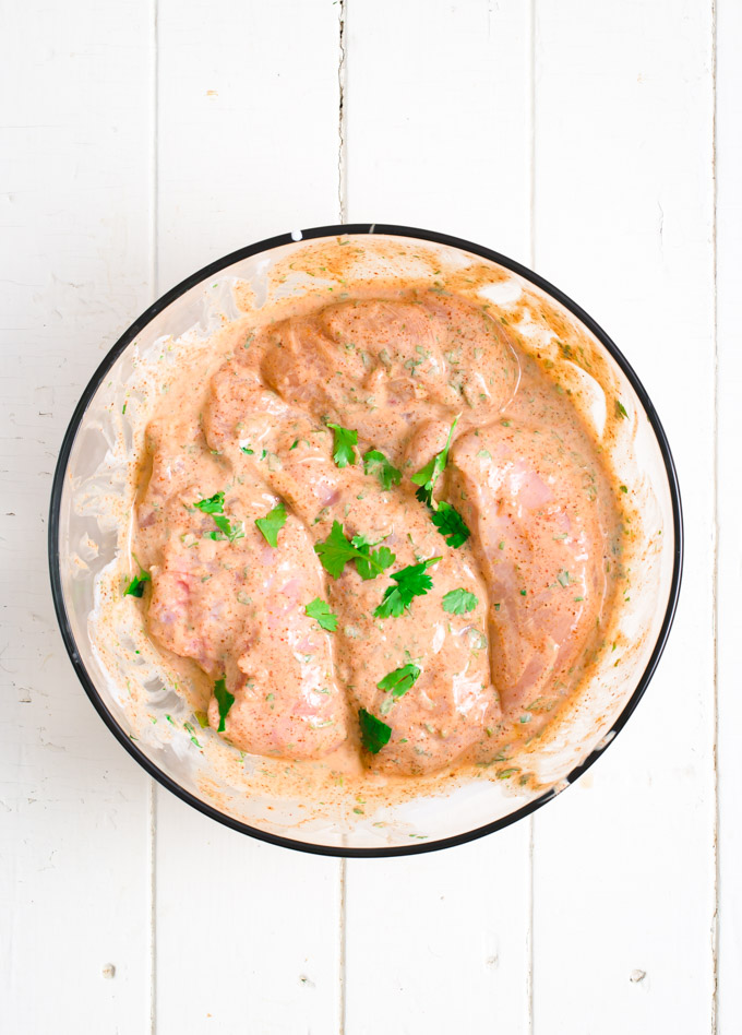 Marinated chicken breasts in a bowl