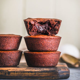 Brownies stacked on a wooden cutting board
