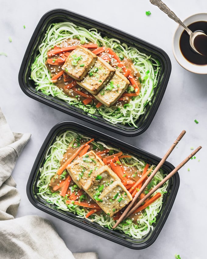 Two Vegan Peanut Butter Tofu on Zoodles servings in meal prep containers