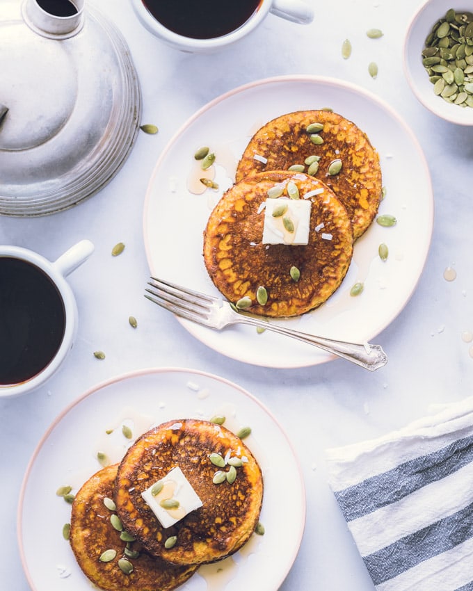 Four Pumpkin Protein Pancakes on two separate plates