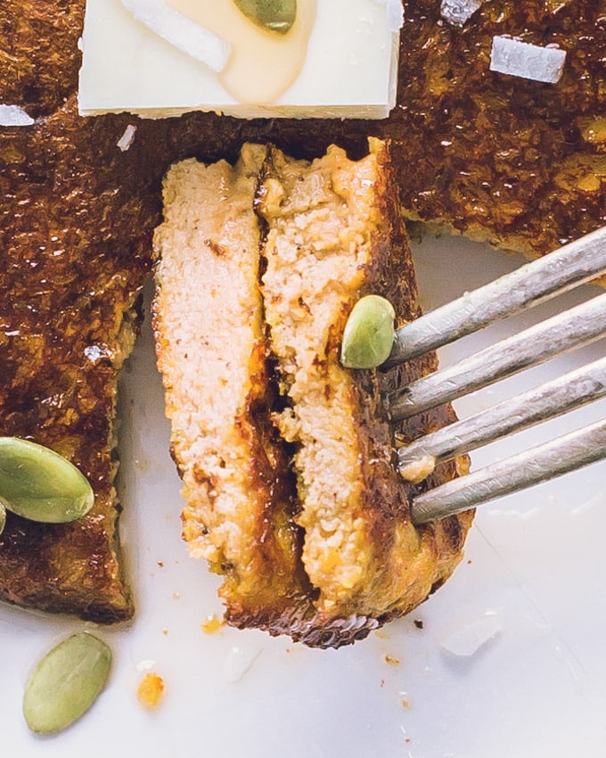 Two bites of Pumpkin Protein Pancakes planted on a fork