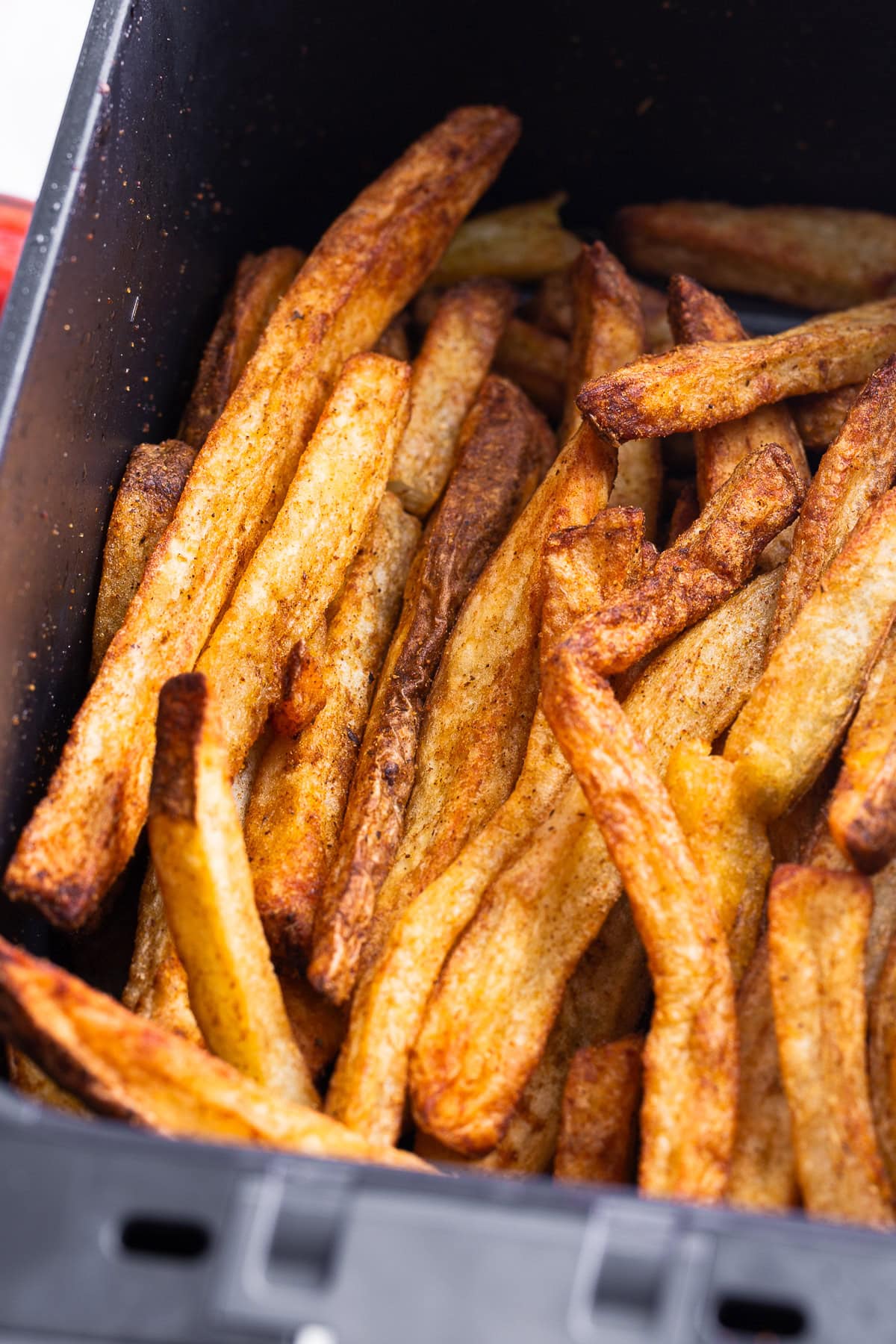 Air Fryer Steak Fries in a air fryer basket close up shot